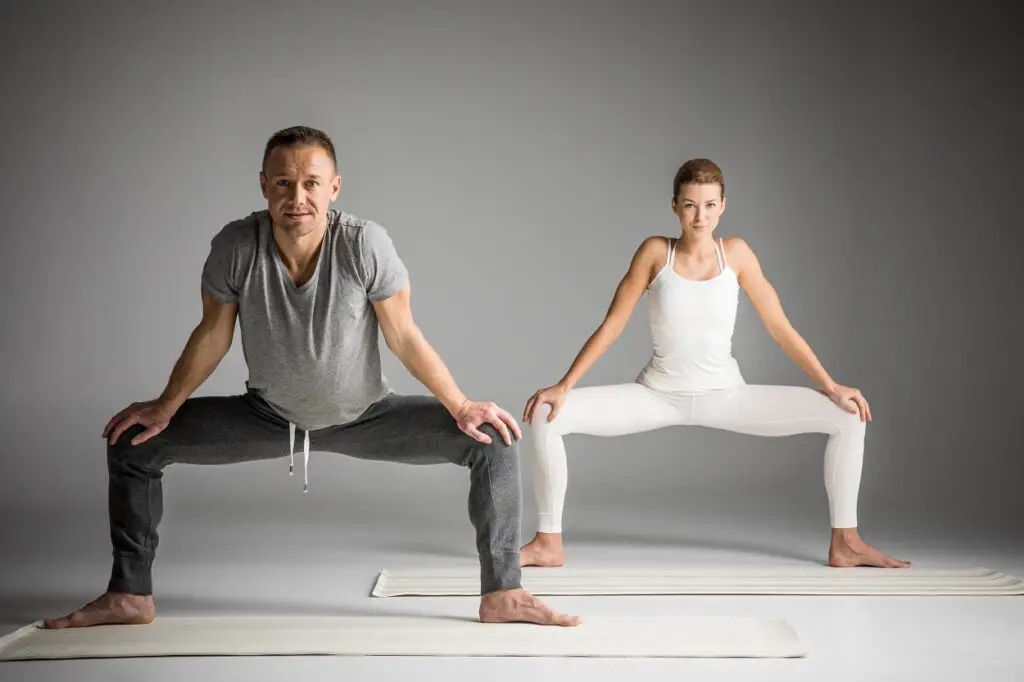 Man and Woman Doing Sumo Squat Exercise